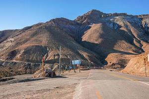 estrada curva de asfalto vazio através de montanhas em dia ensolarado de verão foto