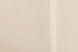 costura interna em pano de linho branco, como plano de fundo