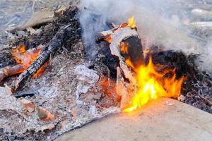 parada de acampamento com fogo brilhante com fumaça na lareira ao ar livre foto