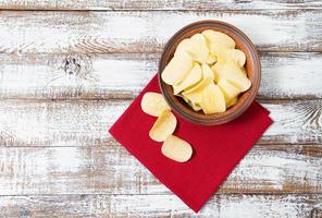 batatas fritas, guardanapo vermelho na mesa de madeira. conceito de férias de toalha de mesa foto