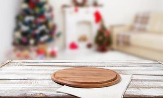 mesa de corte, guardanapo branco na mesa de madeira no interior de férias turva, ano novo e conceito de natal, toalhas de mesa foto