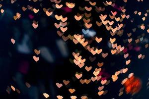 laranja bokeh e borrão forma de coração amor dia dos namorados colorido luz noturna foto