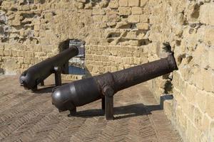 um velho canhão no castelo castel del ovo em um dia ensolarado. foto