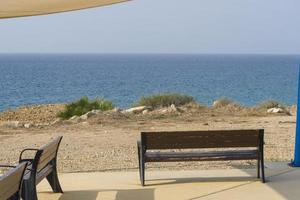 bancos com vista para o mar na ilha de chipre, perto de Paphos. foto