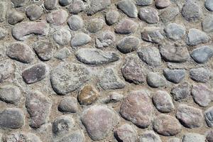 textura de paralelepípedos cinza de um terreno com muitas pedras foto