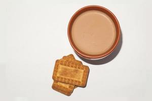 conceito de café da manhã. xícara de chá e biscoito em fundo branco. foto