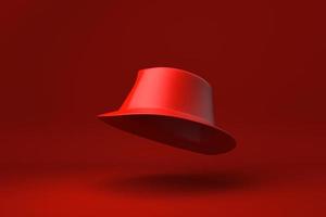 chapéu fedora vermelho flutuando no fundo vermelho. ideia de conceito mínimo criativa. monocromático. renderização 3D. foto