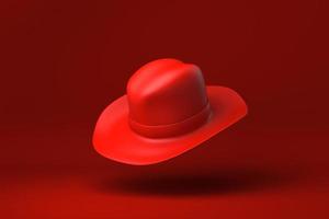 chapéu de cowboy vermelho flutuando no fundo vermelho. ideia de conceito mínimo criativa. monocromático. renderização 3D. foto