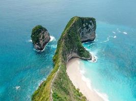 vista aérea de drone da vista para o mar azul da beira-mar na baía de manta ou na praia de kelingking na ilha de nusa penida, bali, indonésia foto