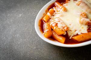 Bolo de arroz coreano em molho coreano picante com queijo, tokpokki de queijo, tteokbokki com queijo foto