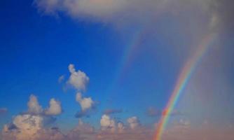 céu de arco-íris com algumas nuvens brancas superfície fluxo abstrato nuvens de trovão no céu azul claro. foto