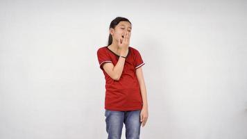 menina asiática colocou a mão perto da boca isolado fundo branco foto