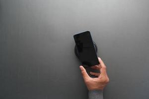 carregar smartphone usando base de carregamento sem fio, vista superior foto