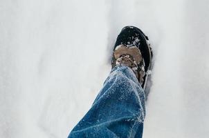 perna masculina andando na neve foto