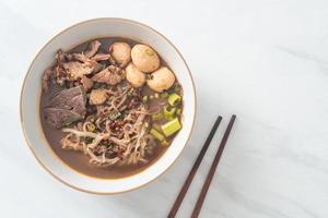 macarrão tailandês com carne de porco, carne de porco estufada, almôndega e fígado de porco em sopa de sangue foto