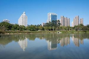 o rio reflete os edifícios modernos da cidade sob o céu azul foto