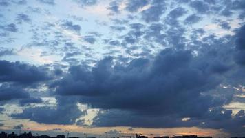 a bela vista do pôr do sol com a silhueta e o céu de nuvens coloridas na cidade foto