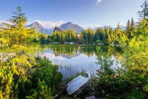 o nascer do sol sobre um lago no parque high tatras. Shtrbske Pleso, Eslováquia foto