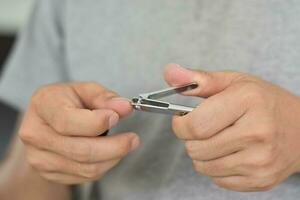 homem cortando unhas usando cortador de unhas, close-up foto