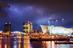 bela noite em amsterdã. iluminação de prédios foto