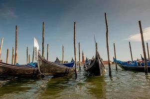 gôndola no cais com fundo giudecca em veneza foto