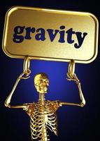palavra gravidade e esqueleto dourado foto