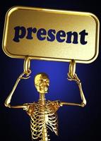 palavra presente e esqueleto dourado foto