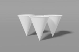 conjunto de três copos de maquete de papel branco em forma de cone em um fundo cinza. renderização em 3D foto