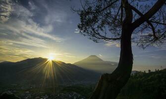 nascer do sol panorâmico nas montanhas localizadas no mirante tieng, regência de wonosobo, indonésia. foto