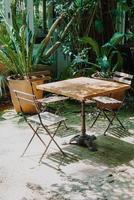 cadeira de madeira vazia e mesa no jardim foto