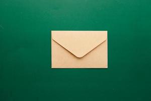 um envelope cai em um fundo de cor verde foto