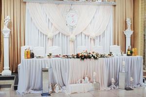 mesa principal decorada de luxo no salão de casamento foto