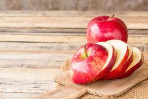 close-up de uma maçã fatiada na mesa de madeira.