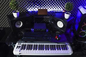estúdio de gravação com teclado, alto-falante e piano elétrico foto