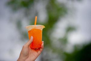 mãos e delicioso suco de laranja para beber idéias de bebidas de alimentos saudáveis foto