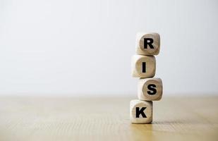 tela de impressão de redação de risco no bloco de cubo de madeira instável para o conceito de gerenciamento de risco. foto