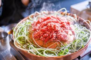 churrasco de carne bulgogi no restaurante coreano em seul, estilo de vida cozinha de comida coreana fresca na panela de cobre com cebola verde fatiada, close-up, copie o espaço foto