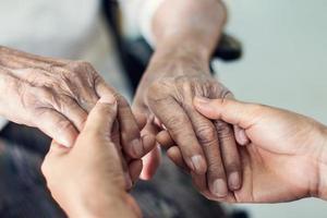 feche as mãos de ajudar as mãos de cuidados domiciliares de idosos. mãe e filha. saúde mental e conceito de cuidado de idosos foto