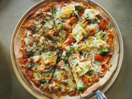 close-up de pizza com abacaxi e legumes no prato foto