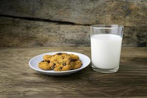 biscoitos e um copo com leite com uma nota branca para o Papai Noel foto