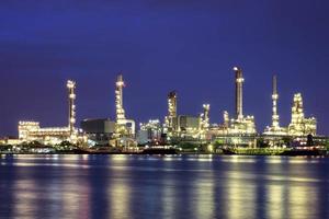 refinaria de petróleo no crepúsculo com reflexão foto