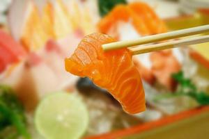 sashimi de salmão com fundo de conjunto de sashimi foto