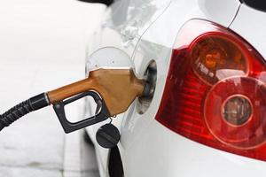 para encher a máquina com combustível. carro encher com gasolina em um posto de gasolina. bomba de posto de gasolina foto