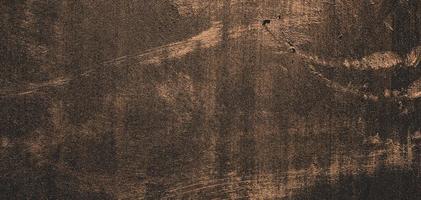 textura de fundo de parede de concreto escuro com gesso, fundo de parede sujo abstrato de pedra foto