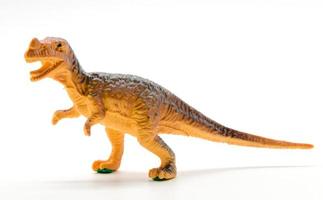 modelo de brinquedo de dinossauro tiranossauro em fundo branco foto