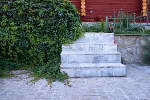 escadaria de pedra perto das hortaliças e casa de madeira foto