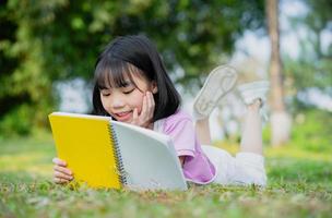 imagem de menina asiática estudando no parque foto