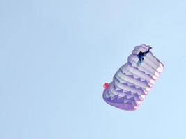 um pára-quedas sobre um fundo de céu azul foto