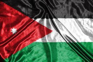 bandeira de pano da jordânia bandeira de cetim acenando textura de tecido da bandeira foto