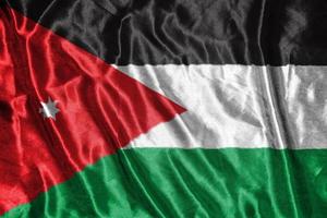 bandeira de pano da jordânia bandeira de cetim acenando textura de tecido da bandeira foto